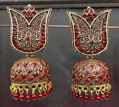 Perfect with ethnic & traditional wear. Fancy Party Wear Traditional Jhumki Earrings. Perfect gift for any occasion for yourself and your dear ones. It is advisable to store jewellery in a zip lock pouch (air tight pouch), keep away from water perfume and other chemicals and clean it with dry and soft cloth. Bollywood Style Jhumkas For Navratri With Intricate Design, Red Jhumkas With Intricate Design For Diwali, Temple Jewelry Style Jhumkas For Eid, Temple Jewelry Jhumkas For Festive Eid, Temple Jewelry Jhumkas For Festive Eid Occasions, Festive Red Jhumkas With Stone Work, Red Chandbalis With Intricate Design For Festivals, Traditional Heavy Tikka For Party, Red Danglers With Intricate Design For Diwali