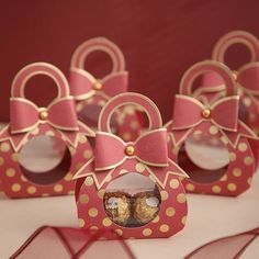 some pink boxes with gold polka dots and bows