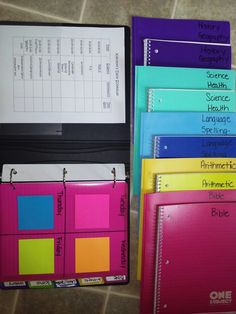 several binders are stacked on top of each other