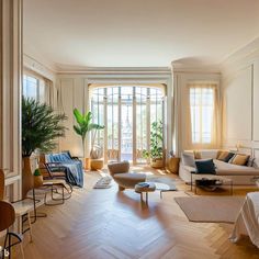 a living room filled with furniture and lots of windows