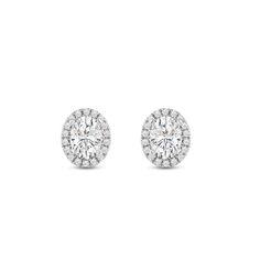 Classic oval cut earrings with a stunning halo of round stones encircling the center stone.A lovely outfit-maker, this pair of stud earrings is what you need to give any ensemble a polished, put-together finish. Diamond Halo Earrings, Halo Diamond Earrings, Cut Earrings, Gorgeous Engagement Ring, Halo Earrings, Outfit Maker, Diamond Halo, Oval Diamond, Conflict Free Diamonds