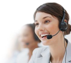 a smiling woman wearing a headset with two other women behind her in the background