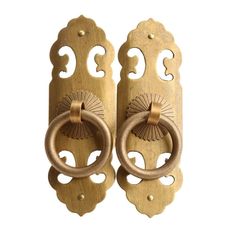 two wooden door handles with decorative designs on them