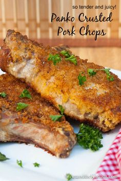 two pork chops on a plate with parsley sprinkled around the edges