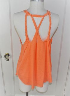 an orange tank top is displayed on a mannequin