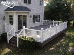 a white house with a deck in front of it