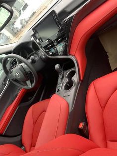 the interior of a car with red leather seats