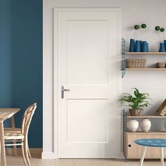 a room with blue walls and white doors