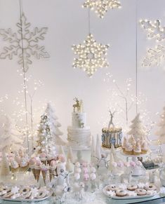 a table topped with cakes and desserts covered in frosting snowflakes