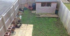 a small backyard with lots of pots and plants in the grass next to a shed