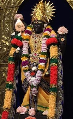 the statue is decorated with flowers and decorations