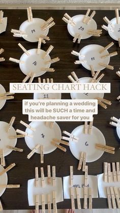 a table topped with lots of white plates and wooden clothes pins on top of each plate