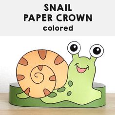 a paper crown with a snail on it and the words snail paper crown colored in white