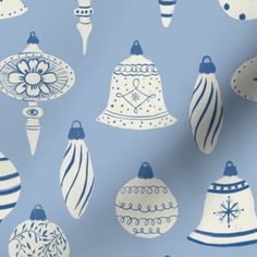 blue and white christmas ornaments on a light blue background