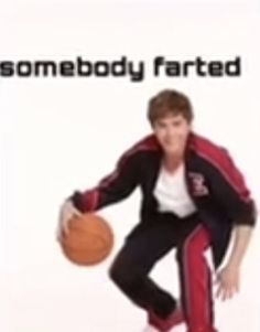 a young man holding a basketball in his right hand while standing next to a white background