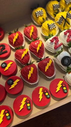 cupcakes decorated like the flash man are on display