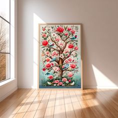 a tree with birds and flowers painted on it is in an empty room next to a window