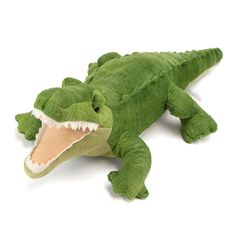 a stuffed alligator is laying down with its mouth open