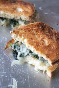 two grilled sandwiches with spinach and cheese