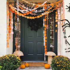 a front door decorated for halloween with decorations