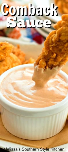 a spoon full of sauce being lifted from a white bowl with chicken wings in it