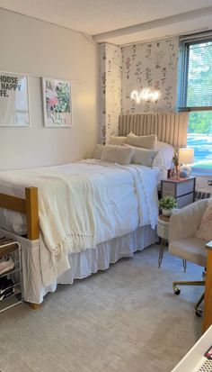 a bedroom with a bed, chair and pictures on the wall