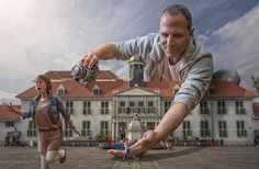 a man and woman are playing frisbee in front of a large building