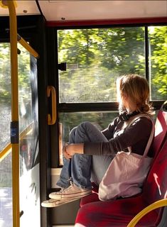 a woman sitting on a bus looking out the window