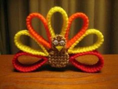 a crocheted turkey sitting on top of a wooden table