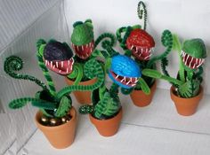 some plants with fake teeth are in pots