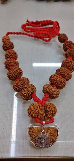 Name: Rudraksha Siddha Mala Configuration: 1 to 14 mukhi + 1 Pcs Gaurishanker + 1 Pcs Ganesha Rudraksha. (Total: 16 Pcs) Size: 20 to 24 mm approx. Origin: All Nepalese except 1, 2 Mukhi Indian Quality: 100% Authentic - Superfine Note: Due to Natural Seed color varies from light brown to dark brown. Rudraksha Siddha Mala is a very powerful healing combination. Worn for Dharma, Artha, Kama, Moksha. The synergistic combination of all mukhis worn on the body provides the wearer with abundance in wea Hand-strung Mala For Puja, Temple Jewelry Style, Spiritual Temple Necklace With Cutdana For Festivals, Temple Necklace With Round Beads For Puja And Festivals, Spiritual Temple Necklace For Puja And Navratri, Spiritual Temple Necklace With Round Beads For Puja, Spiritual Temple Necklace With Latkans For Festivals, Gift Mala With Cutdana And Round Beads, Spiritual Round Beads Temple Necklace For Puja, Spiritual Festive Mala With Latkans