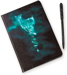 a notebook with a pen on top of it and an image of a horse in the background