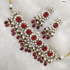 a necklace with red and white stones on it