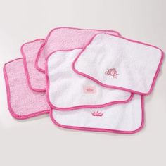 four pink and white towels on top of each other with the word hello kitty printed on them