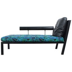 a black bench with a blue and green seat cover on it's back end