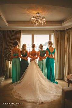 the bridesmaids are looking at each other in their wedding gowns and dresses