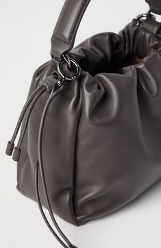 Soft leather is a refined material characterized by a natural grain and a nice supple hand. Drawstring closure Adjustable and detachable shoulder strap Handle Leather lining Internal pocket with zip closure Nickel-free monili decoration Bag is 25 cm (9.84") long, 8 cm (3.15") wide and 18 cm (7.09") high Textured Leather Evening Pouch Bag, Modern Leather Clutch Bucket Bag, Evening Textured Leather Pouch Bag, Soft Leather Clutch Bucket Bag, Evening Soft Leather Pouch Bucket Bag, Soft Leather Crossbody Hobo Bag For Formal Occasions, Formal Soft Leather Hobo Crossbody Bag, Formal Hobo Pouch Bag With Adjustable Strap, Evening Bucket Bag With Textured Leather And Double Handle