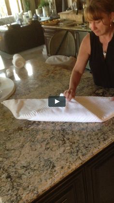 a woman cutting up some paper on top of a counter