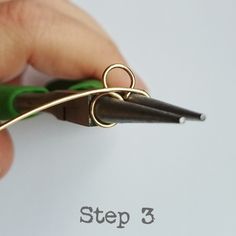 a hand holding a pair of scissors over a piece of paper with the words step 3 written on it