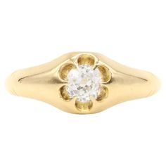 an 18ct gold ring set with a single round brilliant cut diamond in the center