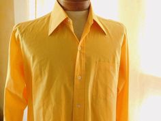 Label:  Fashion Bar Late 60s /early 70's dress shirt in Indian yellow hue - somewhat large collar along with double barrel cuffs Size: Neck: 15-1/2 / Chest: 44 / Across shoulders: 18" / Sleeves: 23" Condition:  Excellent  AMERICAN VINTAGE CLASSICS RS6322 70's Dress, 60s Men, Double Barrel, Vintage Classics, 70s Dress, Mens Oxfords, Dress Shirt, American Vintage, Button Downs