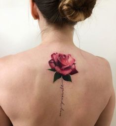 a woman with a pink rose tattoo on her back