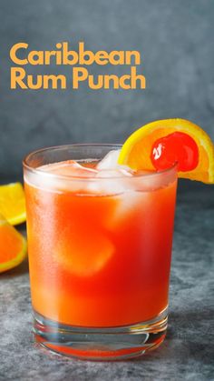 a close up of a drink in a glass with an orange slice on the rim