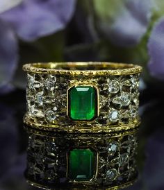 This is a gorgeous 18K white and yellow gold piece. The metal is not stamped, but carefully tested and guaranteed to be 18K. The ring is very similar to Buccellati style, but not Buccellati. The central genuine earth mined emerald measures 5.2mm x 3.9mm and estimated to be 1/2ct. Lovely gemstone! There are 10 diamonds, VS-2 clarity, HI color. Total diamond weight is estimated to be .28 carats. This is an eternity ring, it cannot be sized. Ring size 6-6.25. The weight is 5.6 grams. The band measu Exquisite Gold Emerald Ring For Anniversary, Heirloom Gold Emerald Ring With Vvs Clarity, Heirloom Gold Emerald Ring With Diamond Cut, Elegant Wide Band Collectible Jewelry, Collectible Elegant Wide Band Jewelry, Gold Emerald Ring With Diamond And Hallmarked, Exquisite Gold Emerald Ring With Vvs Clarity, Elegant Yellow Gold Ring With Certificate Of Authenticity, Elegant Gold Emerald Ring With Diamond Cut