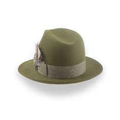 Description Materials Craftsmanship Hat Care Shipping Returns Product Description Elevate Your Look with a Premium Olive Green Trilby Fedora Introducing the Phoenix, a sophisticated olive green medium brim trilby fedora that combines timeless elegance with modern comfort. Crafted from luxurious rabbit fur felt, this hat offers a smooth finish and exceptional durability that will stand the test of time. The classic 4 3/4" center-dent crown and versatile 2 1/4" raw-edge snap brim create a silhouet Homburg Hat, Trilby Fedora, Outdoor Hut, Gambler Hat, Mens Hats Fashion, Fedora Hat Men, Homburg, Chapeau Cowboy, Trilby Hat