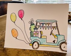 a drawing of a car with balloons attached to the front and side, on top of a table