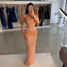 a woman taking a selfie in a dress shop