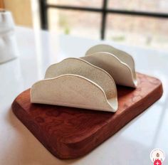 two pieces of food sitting on top of a wooden cutting board