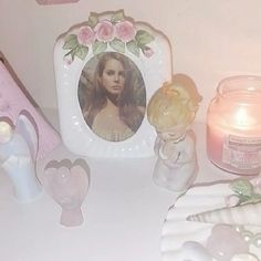 there are candles, figurines and pictures on the table