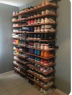 a large shoe rack with many pairs of shoes on it